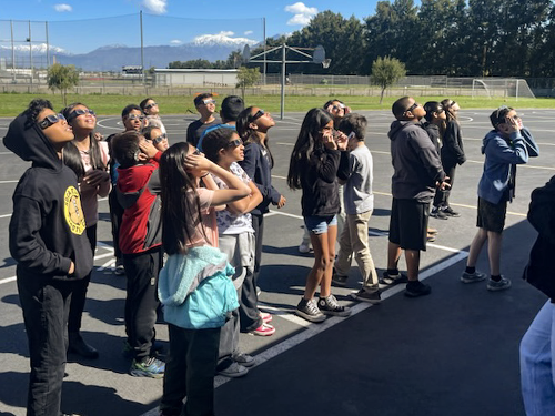 Students looking up at the sky to view the solar eclipse