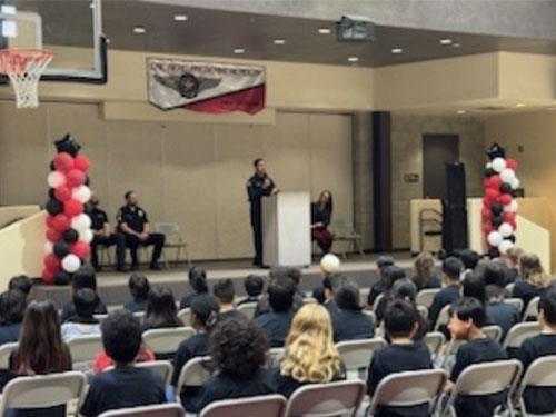 Officer Solano speaking to students inside the Cal Aero multipurpose room