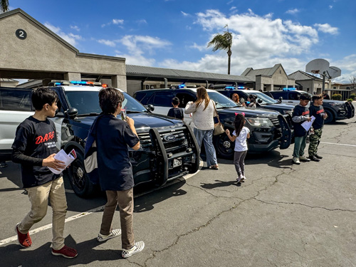 Students checking out Chino PD police cruisers.