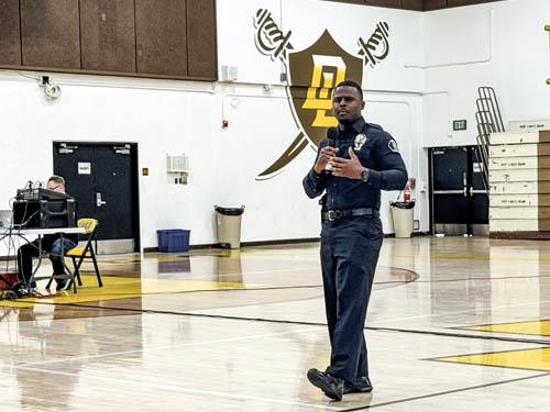Officer Myles Mason speaking at the Don Lugo gym