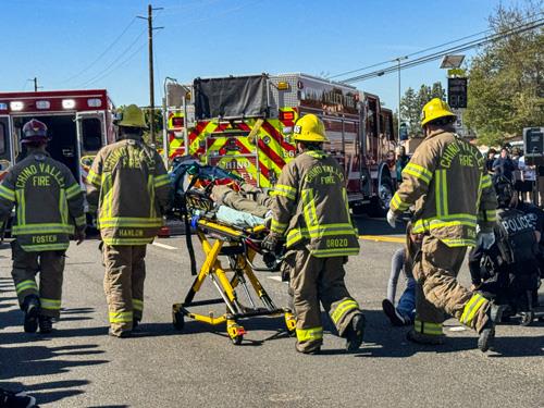 Firefighters moving an injured crash victim on a stretcher